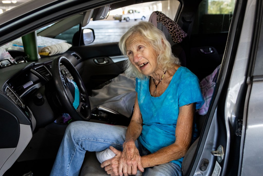 Susan sits in her car in a Parkway Plaza parking garage in El Cajon on Thursday, July 24, 2025. / Brittany Cruz-Fejeran for Voice of San Diego