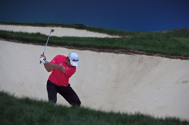 Hideki Matsuyama, of Japan, hits from the sand trap to...