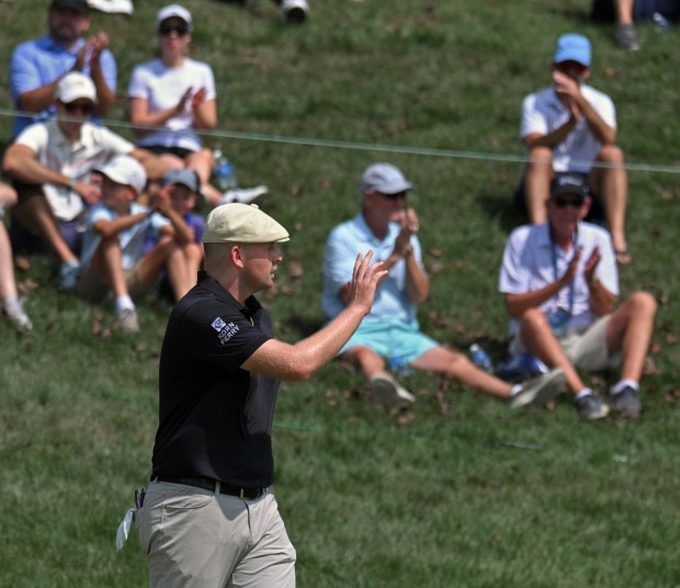 Harry Hall gestures to the crowd after birdieing the 9th...