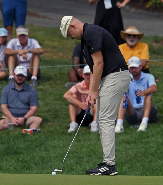 Harry Hall putts for a birdie on the ninth hole...