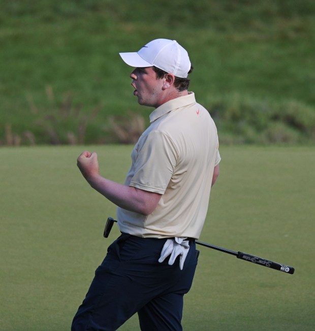 Leader Robert MacIntyre pumps his fist after a 41 foot...