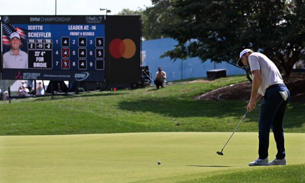 Scottie Scheffler putts the ninth hole during the third round...