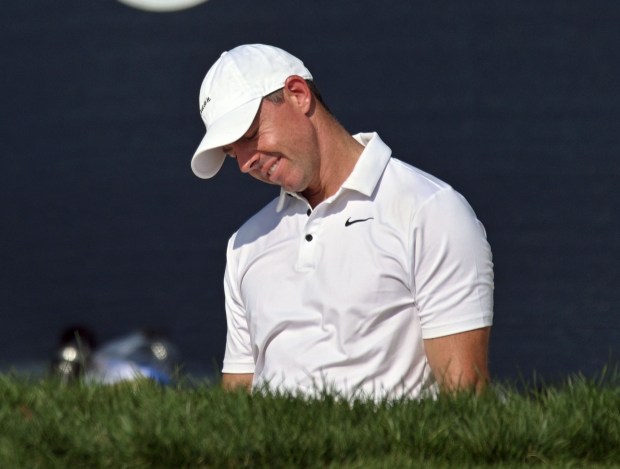 Rory McIlroy reacts after his hit from the sand pit...