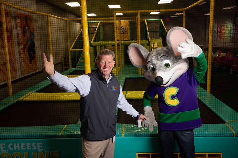 David McKillips, the CEO of CEC Entertainment, poses for a photo with Chuck E. Cheese at...