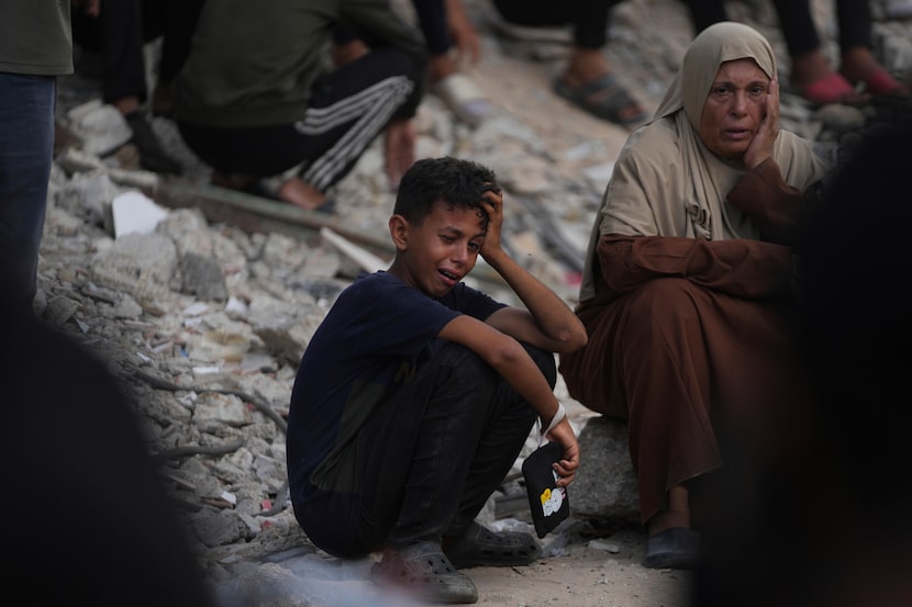Palestinians mourn during the funeral of people who were killed while trying to reach aid...
