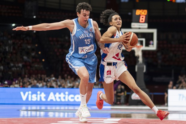Leila Lacan of France, right, and Artemis Spanou of Greece in action during the European Championships basketball match between France and Greece at the Peace and Friendship Stadium in Piraeus near Athens, Greece, Thursday, June 19, 2025. (Alessandro della Valle/Keystone via AP)