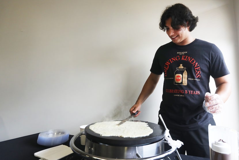 Ahmed Hias makes crepes at BeKinder Coffee, the nonprofit coffee shop founded by...