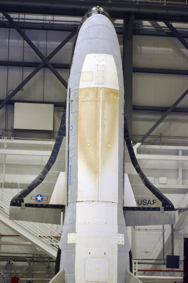 The Boeing-built X-37B spaceplane is encapsulated into its fairing ahead of planned launch atop a SpaceX Falcon 9 rocket for the uncrewed vehicle's eighth mission to space. (Courtesy/U.S. Space Force)