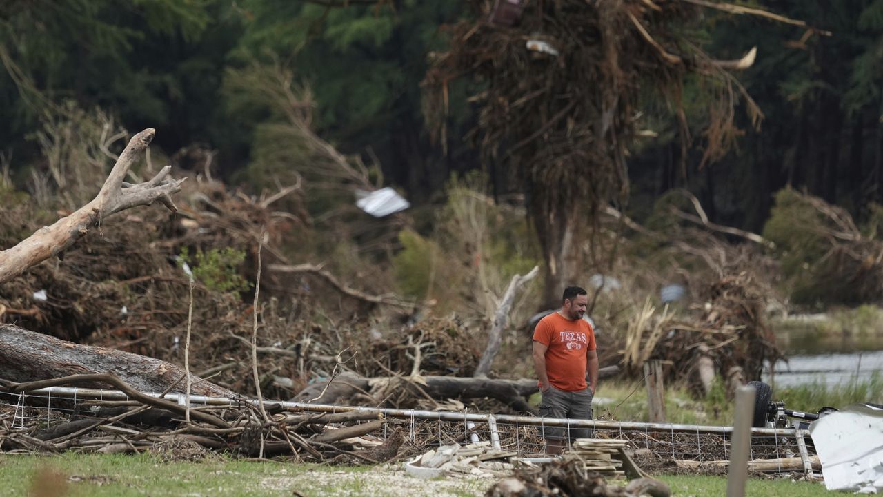 A man surveys debris and flood damage along the Guadalupe River, Sunday, July 13, 2025, in Kerrville, Texas. (AP Photo/Eric Gay)