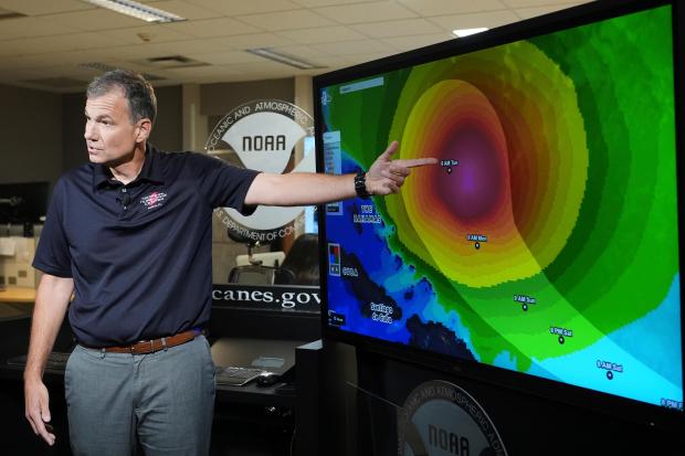 Jamie Rhome, deputy director of the National Hurricane Center, gives an update on Tropical Storm Erin at the National Hurricane Center, Thursday, Aug. 14, 2025, in Miami. (AP Photo/Lynne Sladky)