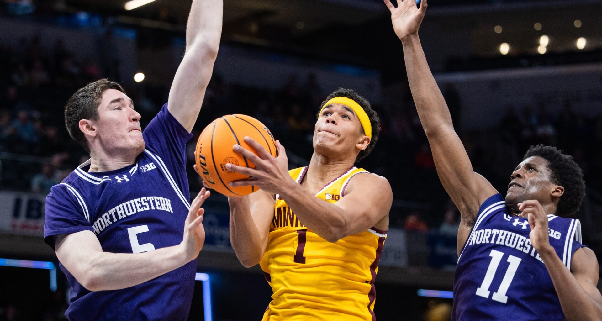 Mar 12, 2025; Indianapolis, IN, USA; Minnesota Golden Gophers guard Isaac Asuma (1) shoots the ball while Northwestern Wildcats center Keenan Fitzmorris (5) and guard Jordan Clayton (11) defend in the second half at Gainbridge Fieldhouse. Mandatory Credit: Trevor Ruszkowski-Imagn Images