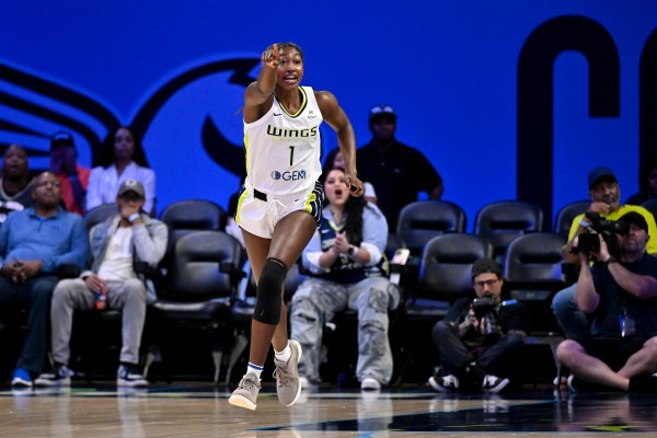 Diamond Miller running and pointing ahead of her.