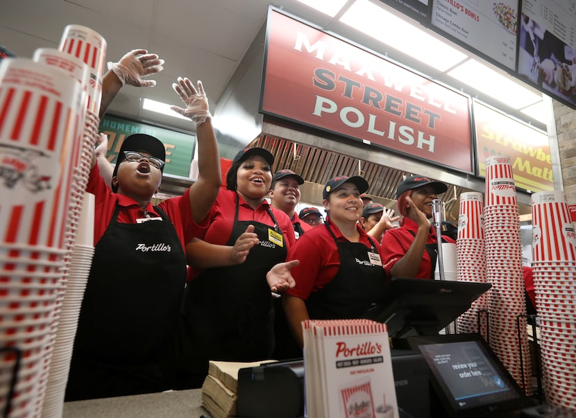 Employees cheer during the grand opening of Portillo's in Allen in September 2023.