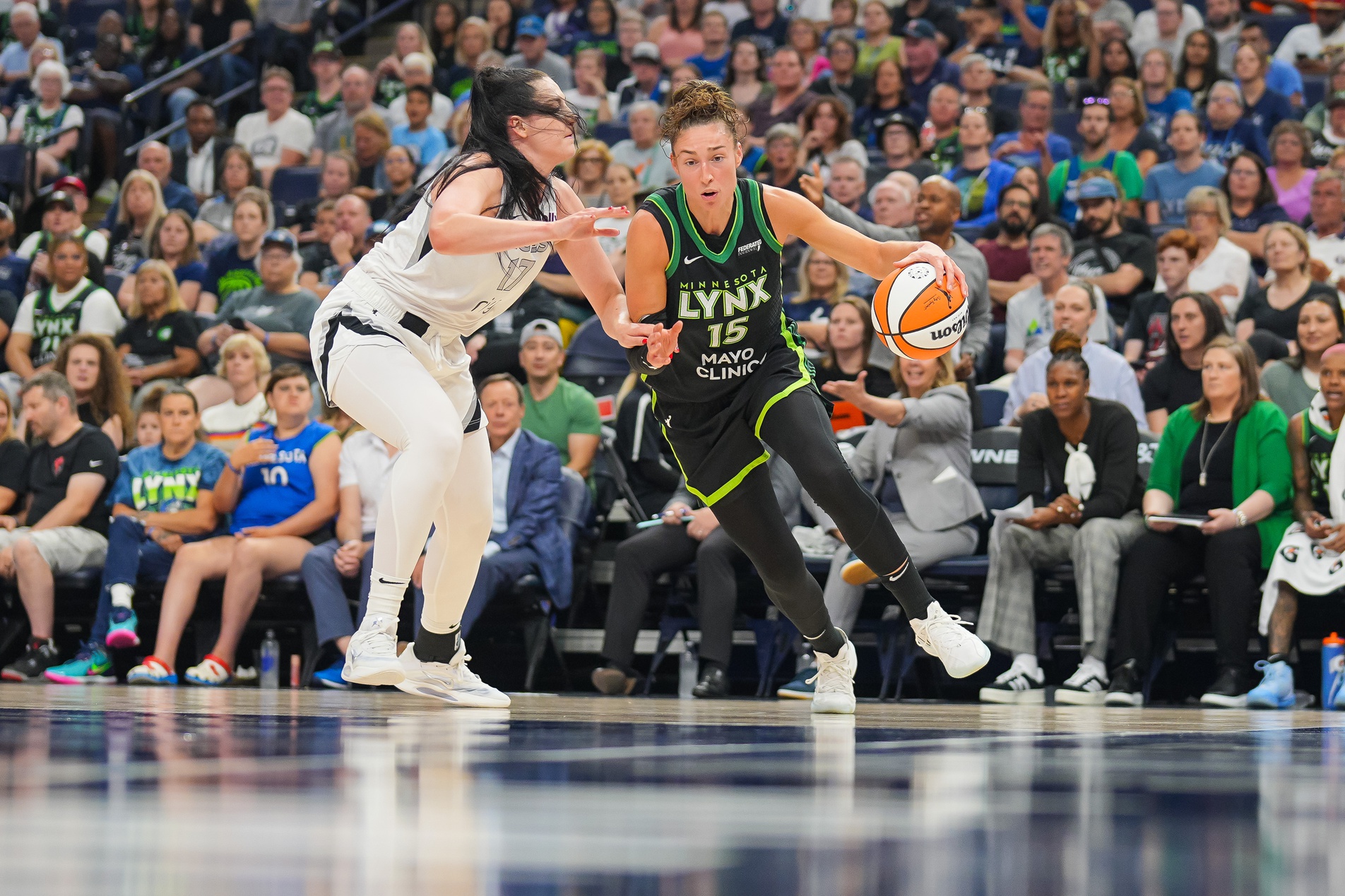 Minnesota Lynx forward Jessica Shepard (15) dribbles against the Las Vegas Aces center Megan Gustafson (17) in the third quarter at Target Center.