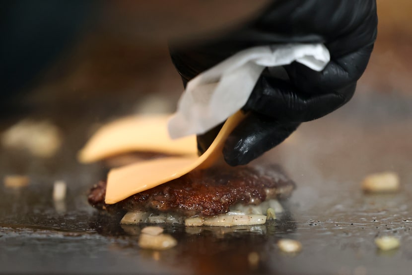 Say cheese! Each beef patty is topped with a Kraft American single. "The best," said NADC...