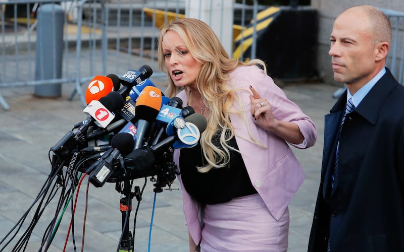 Adult film actress Stephanie Clifford, also known as Stormy Daniels, speaks to media along with her lawyer Michael Avenatti (right) outside federal court in New York City on April 16, 2018.