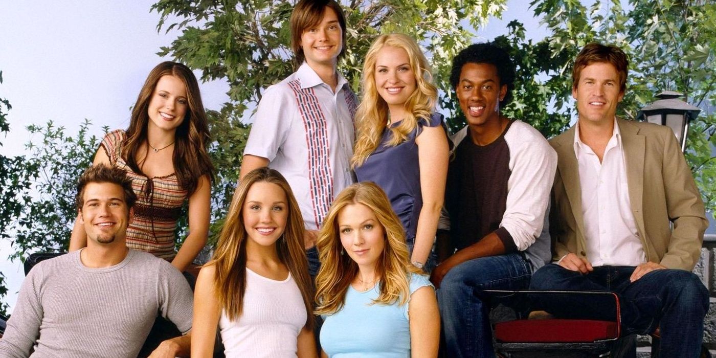 The cast of What I Like About You posing for a promo picture in front of some trees