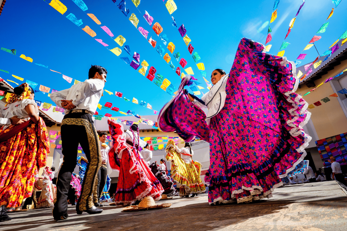 Two dancers perform at an outdoor event.