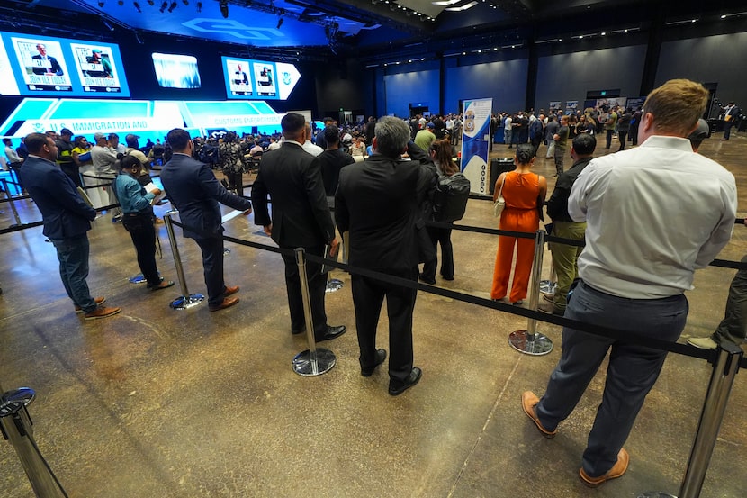 Attendees line up to be checked into an ICE hiring fair Tuesday, Aug. 26, 2025, in Arlington.