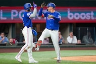 Texas Rangers designated hitter Joc Pederson celebrates with outfielder Leody Taveras (3)...