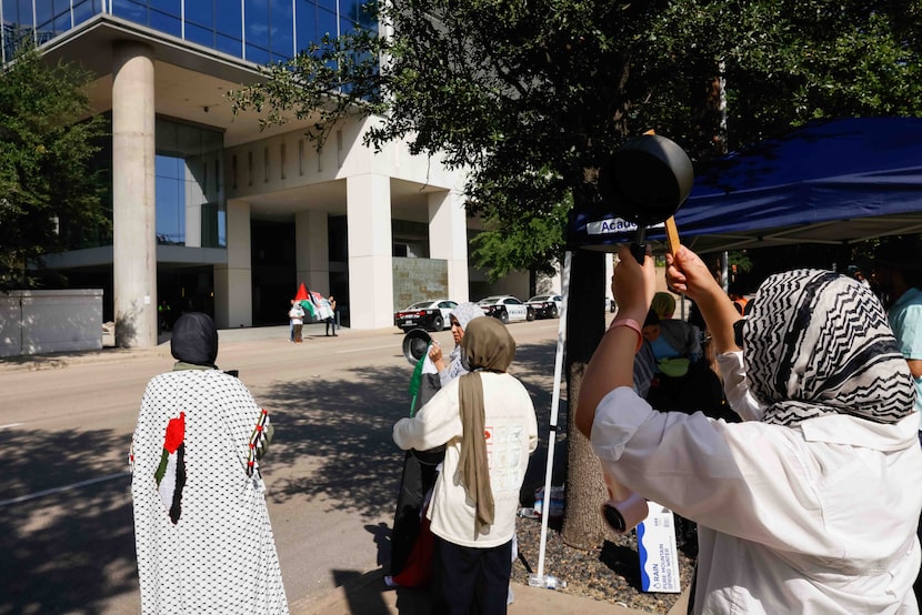 People participate during a BCG Day of Action protest hosted by PYM outside of the Saint Ann...