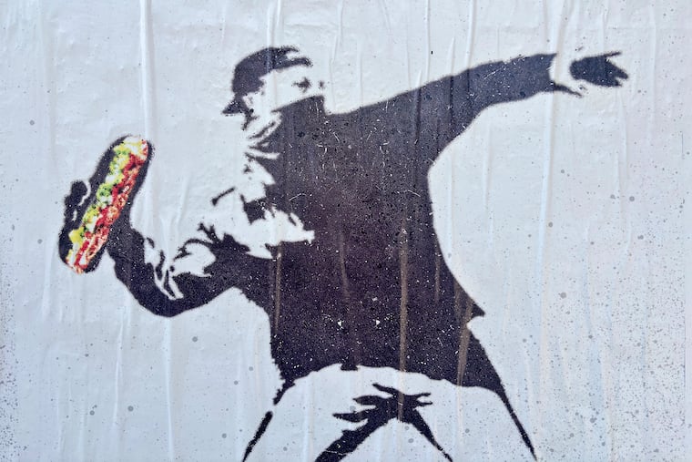 Street art depicts former Justice Department employee Sean Charles Dunn on a wall in the Union Market District neighborhood Aug. 16 in Washington.