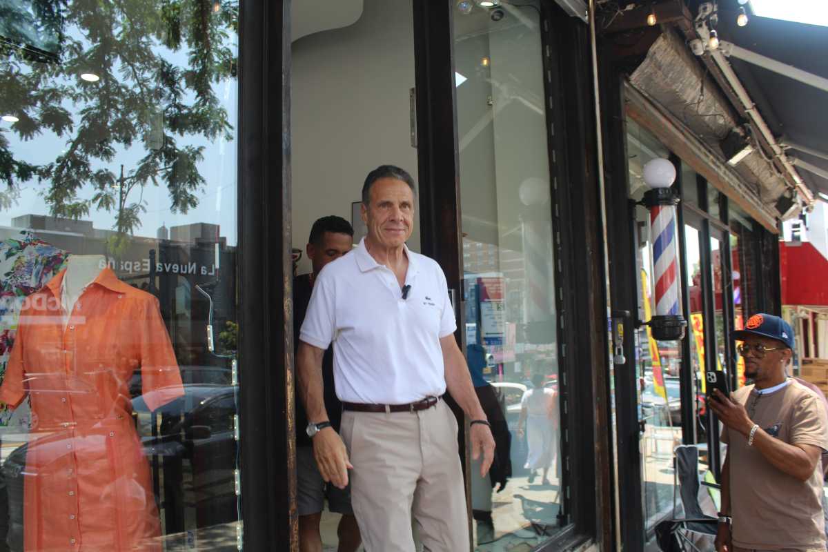 man in white shirt and slacks exits store in mayor's race andrew cuomo