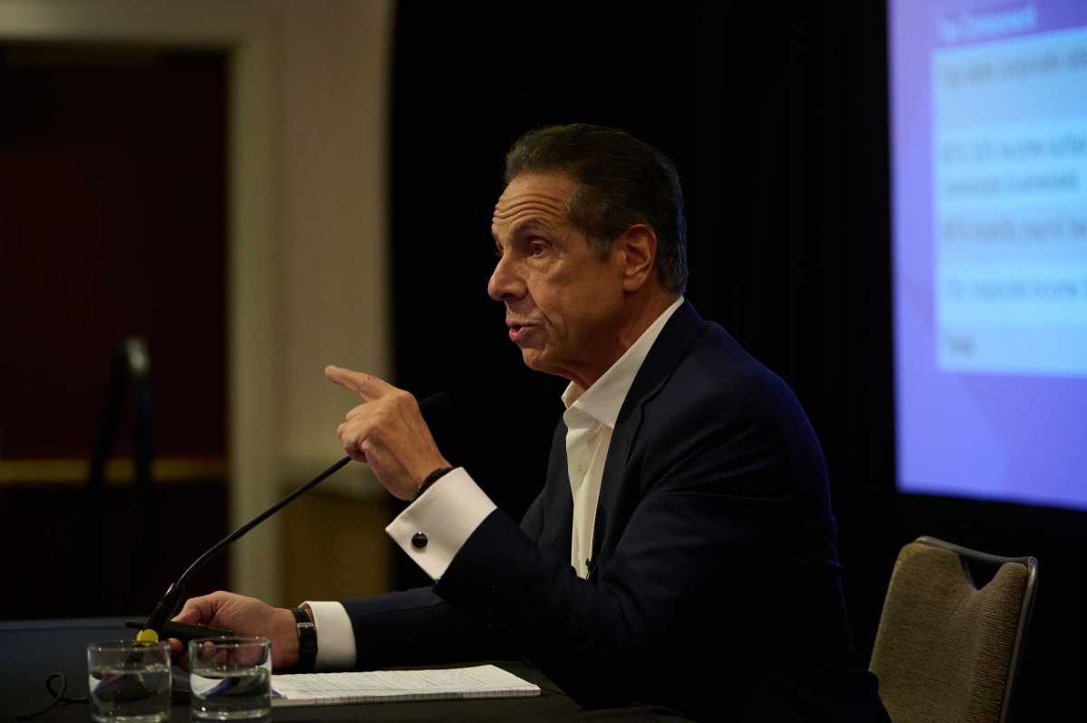 man in suit pointing at microphone andrew cuomo