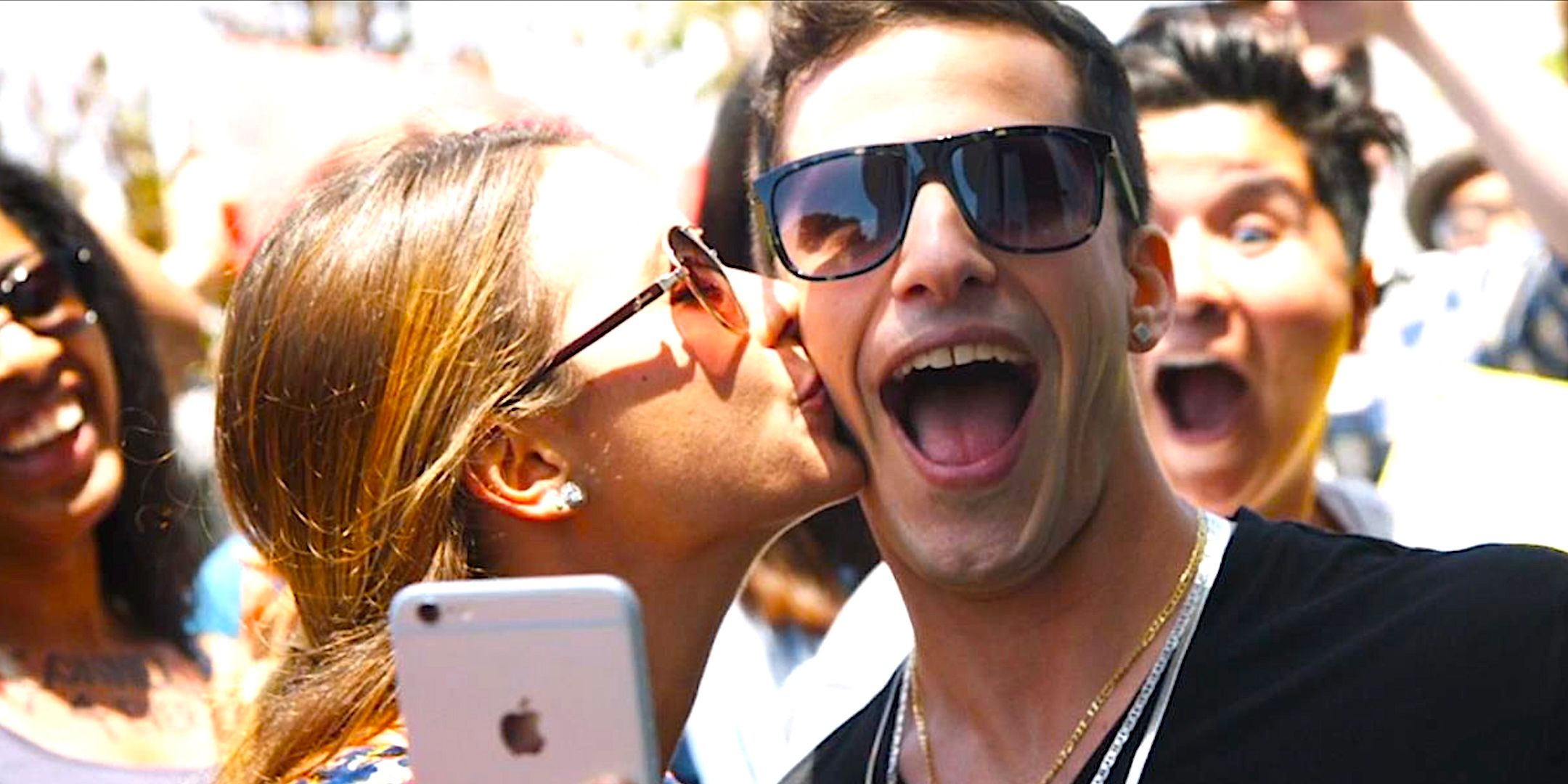 Andy Samberg's Conner4Real smiles as a female fan kisses him in Popstar Never Stop Never Stopping
