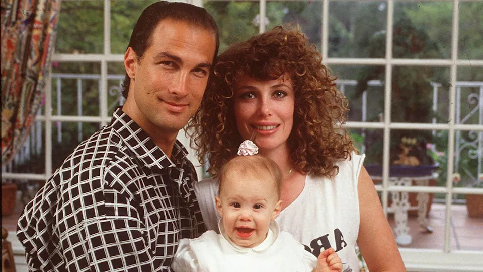 steven seagal and kelly lebrock posing with theirf first child
