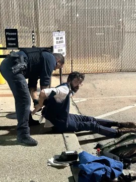 Man being arrested by police.