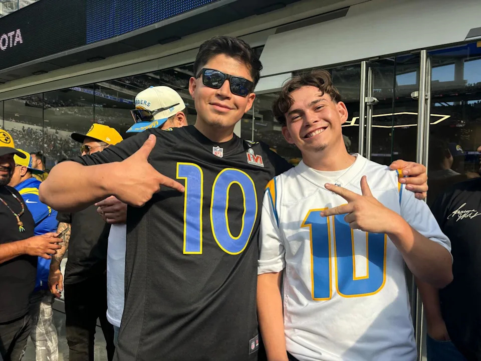 Rams fan Gill Marquez, left, and Chargers fan Eric Robles show their support for their respective teams.