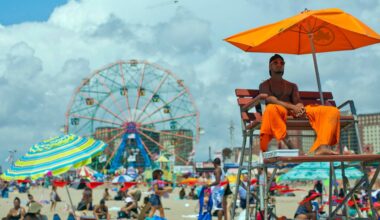 The lifeguard keeps an eye on the swimmers, Saturday, Aug. 20, 2016, on Coney Island in the Brooklyn borough of New York. (AP Photo/Mary Altaffer)