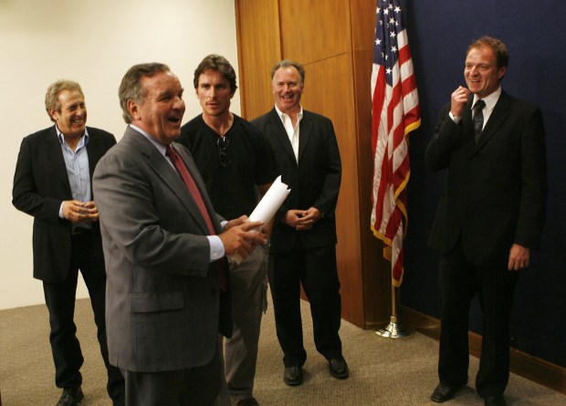 Actor Christian Bale, center, jokes with Chicago Mayor Richard M. Daley, front, during a City Hall news conference on June 8, 2007, promoting the filming of "The Dark Knight." Producer Charles Roven, from left, executive producer Kevin De La Noy and Rich Moskal, right, head of the Chicago Film Office, laugh. Bale asked Daley about the open job of police superintendent. (Chris Walker/Chicago Tribune) 