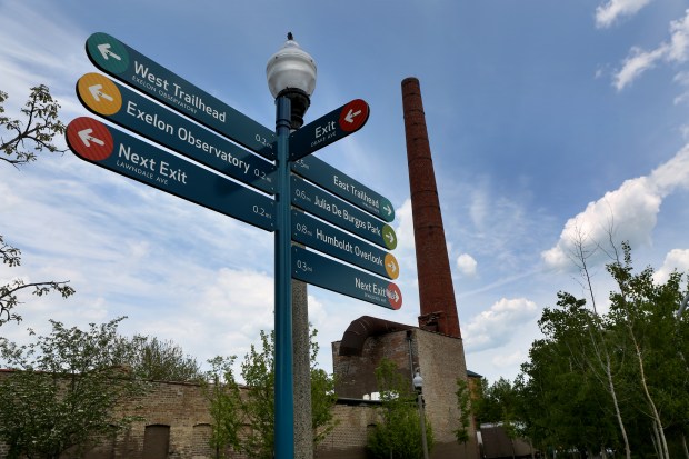 Signs directing people using The 606 trail are at many...