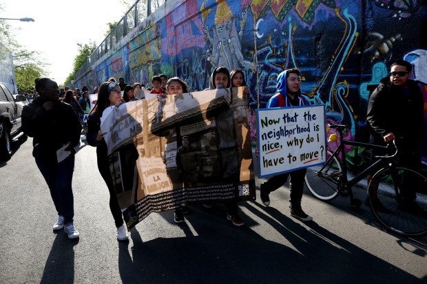 Hundreds of protesters with the Logan Square Neighborhood Association march...