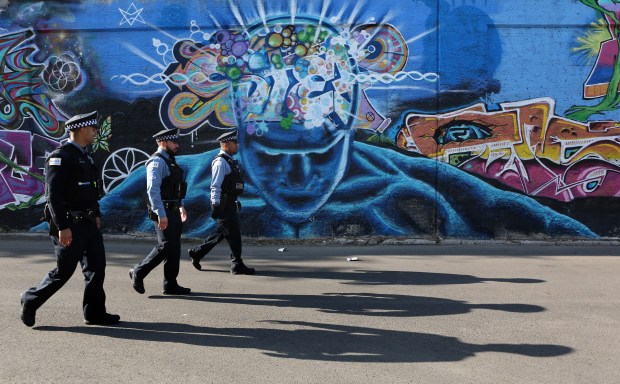 Police officers accompany a group of protesters as they head...