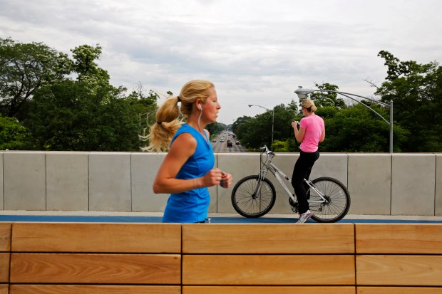 A jogger and bicyclist on The 606 trail at Humboldt...