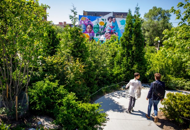 People enter and exit The 606 trail at Park 567...