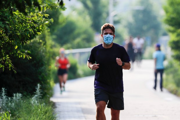 Runners and walkers use the reopened 606 trail on June...