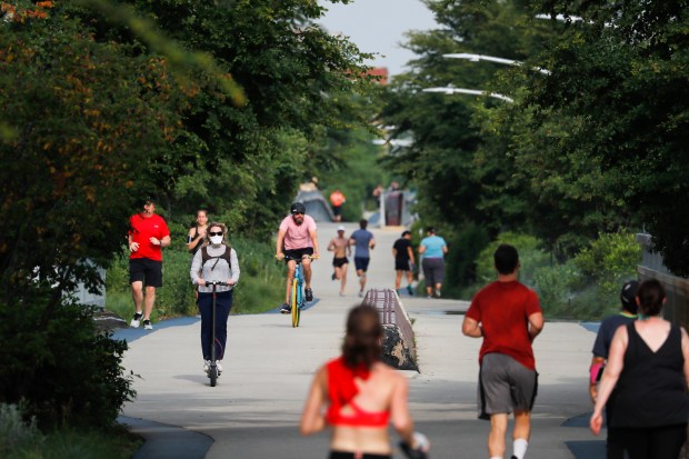 Runners, walkers, scooter users and bicyclists use the reopened 606...