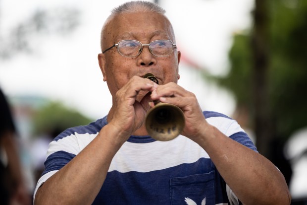 Busker Zhen Jinling plays traditional Chinese folk music on the Suona, a horn instrument, in Chinatown on July 27, 2025, in Chicago. (Dominic Di Palermo/Chicago Tribune)