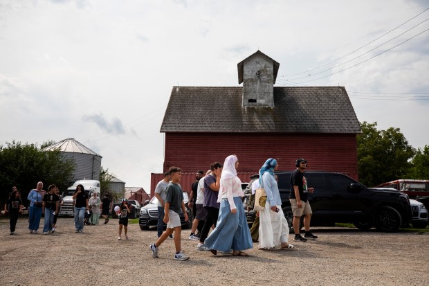 Groups of people head towards the "HEAL on the Farm" event at the Arab Chicago Farm on Saturday, Aug. 16, 2025, in Frankfort. (Vincent D. Johnson/for the Chicago Tribune)