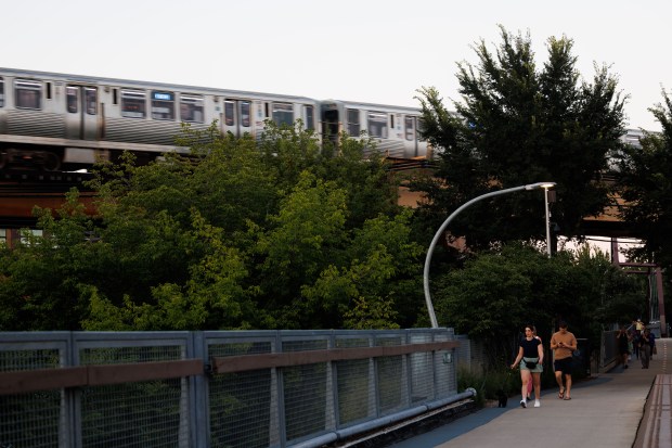 People walk along The 606 trail on Aug. 14, 2025,...