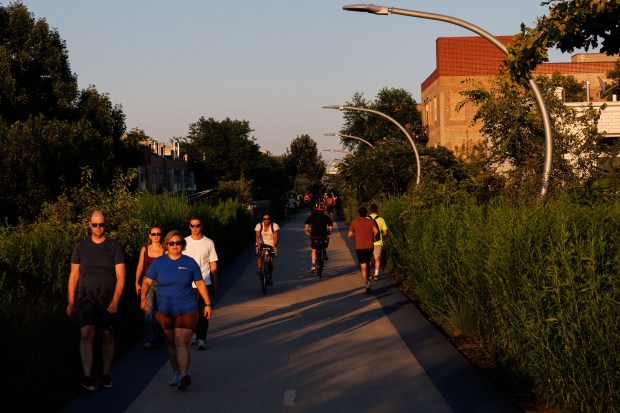 People run and cycle on The 606 in Chicago on...