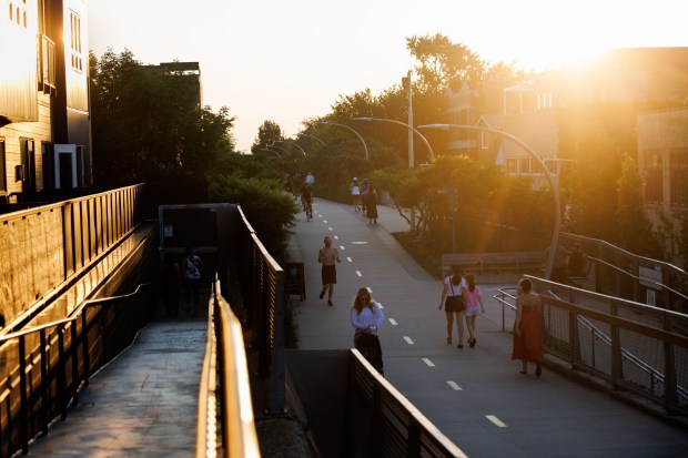 People run and cycle on The 606 trail in Chicago...