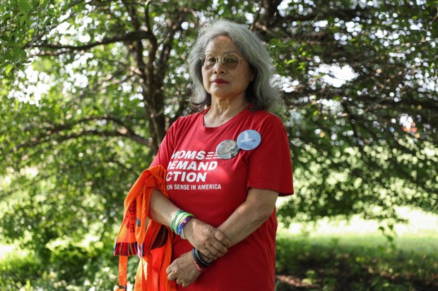 Maria Pike, a gun violence survivor advocate, poses for a portrait during a National Night Out event at Ogden Park in the Englewood neighborhood of Chicago on Aug. 5, 2025. Pike's son was fatally shot in 2012. (John J. Kim/Chicago Tribune)