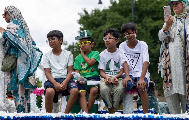 Children ride a float down West Devon Avenue to celebrate Pakistan Independence Day on Aug. 10, 2025, in the West Rogers Park neighborhood of Chicago. (Brian Cassella/Chicago Tribune)