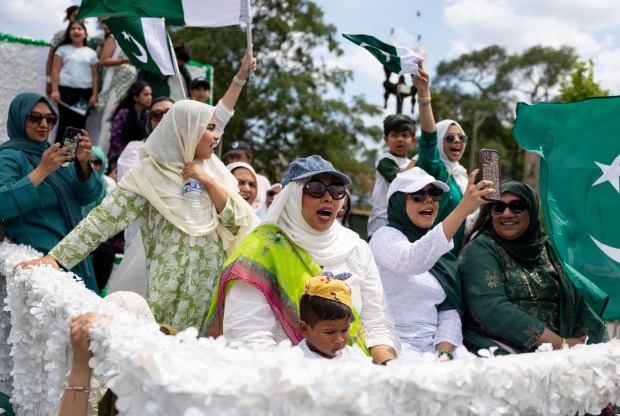 Participants ride a float down West Devon Avenue to celebrate Pakistan Independence Day on Aug. 10, 2025, in the West Rogers Park neighborhood of Chicago. (Brian Cassella/Chicago Tribune)