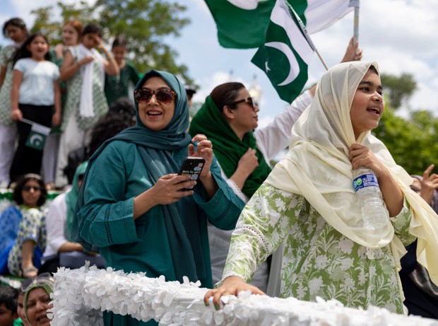 Participants ride a float down West Devon Avenue to celebrate Pakistan Independence Day on Aug. 10, 2025, in Chicago's West Rogers Park neighborhood. (Brian Cassella/Chicago Tribune)